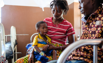 Parents Mariatu Sankoh and Adikali Kamara with their son Mohammed who's receiving treatment in an infant feeding unit at Kambia Hospital. Photo: Darren Vaughan/Concern Worldwide