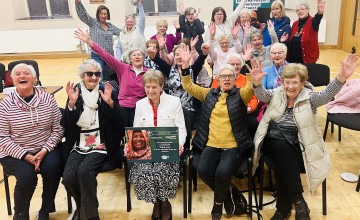 Nellie holding a Concern plaque, along with other Concern volunteers. Photo: Concern Worldwide.