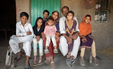 Maula Dinno, a farmer in Sindh, with his wife and his children at their home