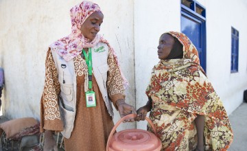 Concern team member Yanna Yagoub Arabi Fadul with Anjama Adam at a distribution of hygiene kits in West Darfur, Sudan, to vulnerable households. Photo: Kieran McConville/Concern Worldwide