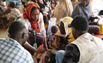 Concern Health and Nutrition Officer, Yamen Nassir, with Salwa Abaker and baby Adan at Ardamata Health Centre in West Darfur, Sudan. Adan is severely acutely malnourished and has additional health complications. Photo: Kieran McConville/Concern Worldwide