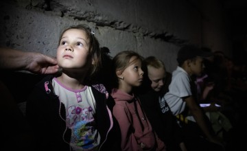 Children are waiting in the school bomb shelter for the air raid to end. The basement still needs renovation. It’s dark and damp there. Photo: Mykhaylo Palinchak/Concern Worldwide