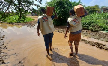 Concern and partner SHACDO staff deliver RUTF supplies on flooded roads due to El Niño. The current situations faced by health and nutrition staff who want to offer their assistance and provide Ready-to-Use Therapeutic Food (RUTF) to children who are malnourished. Photo: Concern Worldwide