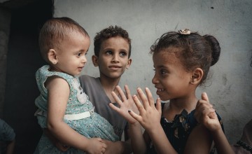 Rima playing with children in Al-Shaqa'a village