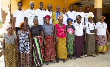 Community members and medical staff outside a health center in Tonkolili, Sierra Leone. A management committee was established with support from Concern, to ensure the security and smooth running of the facility Photo: Kieran McConville/Concern Worldwide