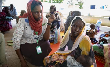Concern Health and Nutrition Officer, Yamen Nassir, with Zarina* and baby Yaqub* at Ardamata Health Centre in West Darfur, Sudan. Yaqub* is severely acutely malnourished and has additional health complications. Photo: Kieran McConville/Concern Worldwide