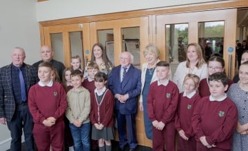 President Higgins and Sabina Higgins with pupils and teachers from Bunscoil Mhic Reachtain and Concern's Amelia Deehan