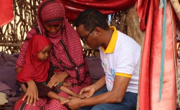 A mother-to-mother support group programme participant and her daughter in Dollo, Ethiopia recieve a health check. The aim of the group is to improve child health and empower mothers to manage their childrens nutrition effectively. Photo Adnan Mohamed Afar/Concern Worldwide.