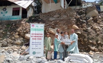Family receiving dry food ration packs in Pakistan