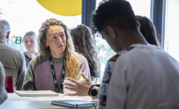 Two people sit and talk