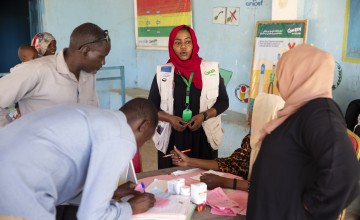 Concern staff in Sudan standing at table and speaking