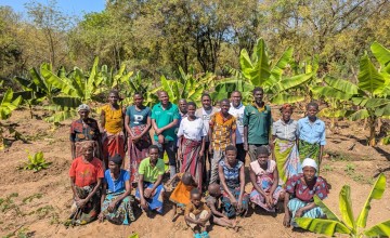 Concern Malawi Team standing with banana sucker recipients in Traditional Authority Ndamera in Nsanje District. Photo: Concern Worldwide.