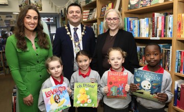 Four children with books and three grown ups
