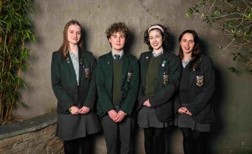 Four secondary school students standing together
