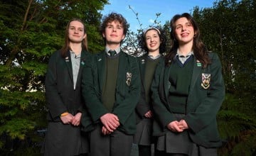 Four secondary school students standing together