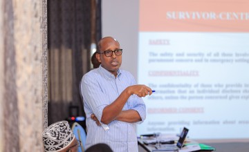 A man talking at a conference event.