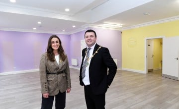 A man and woman standing in an empty shop