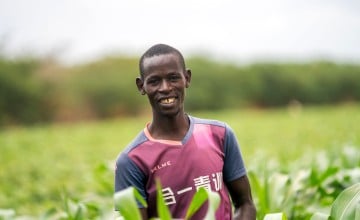 A man standing in a field of maize