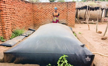Ligness Mpoto of Mtali Village in the Kakuyu Watershed with her biodigester. Photo: Concern Worldwide.