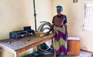 Ligness with her old cook stove. Photo: Concern Worldwide.