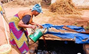 Ligness and her liquid fertiziler harvested and ready for use. Photo: Concern Worldwide.