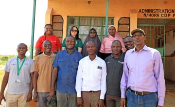 A group of people standing outside a school