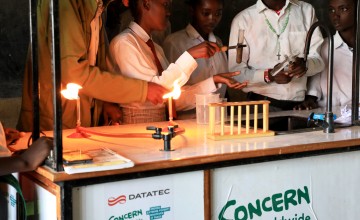 Students carrying out a science experiment using bunsen burners and test tubes