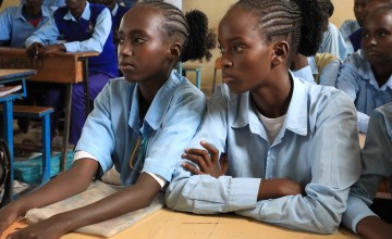 Two young female students in their classroom