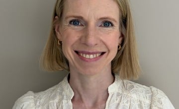 Headshot of a woman smiling with short blonde hair