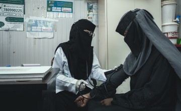 Woman providing health check up to a patient