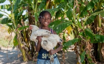 Joyce, 8, holds a chicken that was provided as part of Concern's RAIN programme to her mother Lillian Shachinda in Zambia. Photo: Gareth Bentley / Concern.