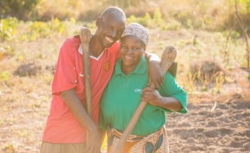Chibala, 55, and Catherine, 43, work together in their field. Through attending gender training as part of Concern's RAIN programme he has now 'learned to help' his wife. Photo: Gareth Bentley.