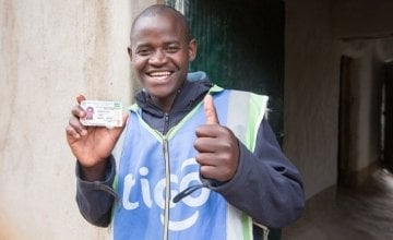 Jean Claude Minani shows off his prized motorcycle driver’s licence. He participated in Concern’s graduation programme in Rwanda and was able to start his own motorcycle taxi business. Photo: Robin Wyatt / Concern Worldwide, 2015
