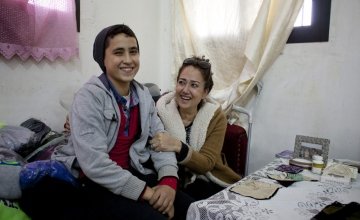 Rabia, a member of the Concern-funded sewing workshop in Tripoli, Lebanon, with her son. Credit: Abbie Traylor-Smith/Panos for Concern Worldwide
