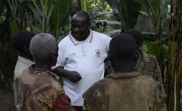 Concern Project Supervisor Joseph Nkengurukiyimana talks to members of the marginalised Batwa community outside their homes on a remote hillside of Kabere, Mabayi, Cibitoke, Burundi.
