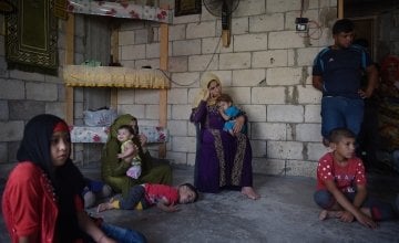 *Kafya, 30, centre, sits with her family who all share a house which Concern will be fitting with windows and doors, in Northern Lebanon. Photograph by Mary Turner/Panos Pictures for Concern Worldwide  *name changed for security reasons