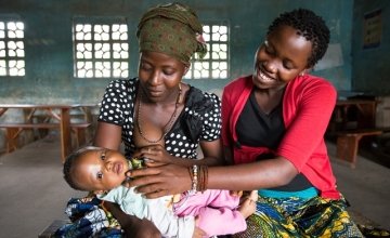 Pictured are Safiatu Kamara with her baby daughter, Awanatu and Fatumata Kabia, who is pregnant with her first child. They are attending a gathering of the Adolescent Reproductive and Sexual Health groups in the town of Mapaki. Photo: Ki