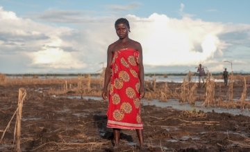Farmer Malita (25) inspects what's left of her field after extensive flooding. The entire crop has been ruined just one month before harvest. Photo: Gavin Douglas/Concern Worldwide.