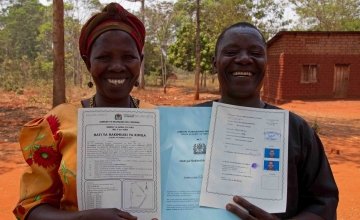 Thomas Vincent Maylinga (53) and Kaleta Sharaba Kabika (47) with their joint land certificate, Kigoma Region, Tanzania. Photo: Jennifer O'Gorman/Concern Worldwide.