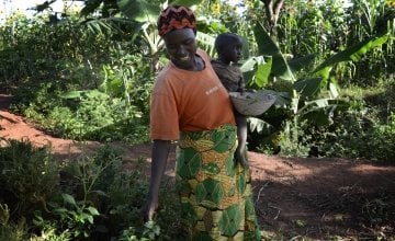 Esperence Mutetiwabo and her two-year-old daughter Delphine collect amaranth leaves from their kitchen garden in Kirundo province, in Burundi. 