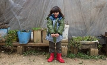 Syrian refugee Ola, wears her winter clothes that were distributed to her by the Concern team at the informal tented settlement in the village of Bebnine, in Akkar, north of Lebanon. Photographer: Dalia Khamissy