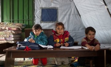 Syrian refugee children in a non-formal education program at an informal tented settlement in Mohamara, near Halba, in Akkar, north of Lebanon Photographer: Dalia Khamissy
