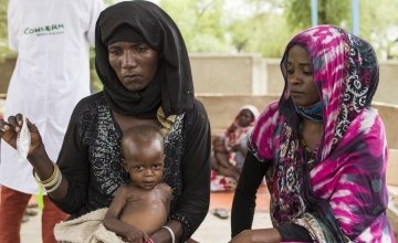 Health volunteer, Iklass Mahamat Tom, accompanies neighbor Fatime and her infant daughter, Falmata, to a health clinic in Koutoufou, Chad.