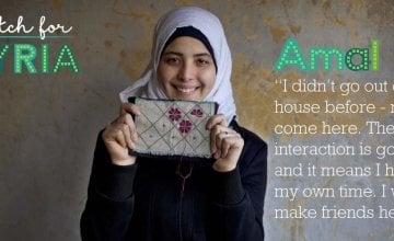Stitch for Syria: Amal holding up a cross stitch pattern. Credit: Abbie Trayler-Smith/Panos Pictures for Concern Worldwide
