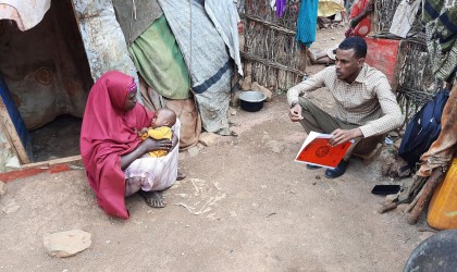 Graduation Caseworker Ibrahim Abdi Ali visiting Fahima* and her son Abdirizak* in their household in Baidoa. Photo: Hassan Isgoowe Molsmed. (*pseudonyms to protect their identities).