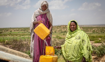 Sahra and Marya collect drinking water from a new water catchment tank. Photo: Gavin Douglas / Concern Worldwide / Somalia