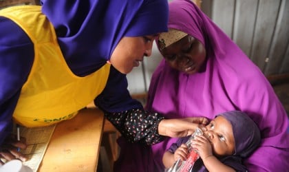 Naima Islow, a Concern nurse provides a medical check-up for Mama Hani* with daughter Nala* in an OTP Centre, in Mogadishu. Photo: Mohamed Addiwahab 