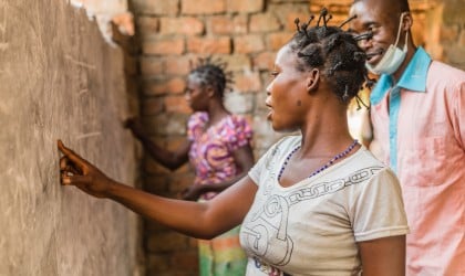 A woman does an exercise on the board at one of Concern’s projects in Manono, Tanganyika for illiterate women. Photo: Pamela Tulizo/Panos/Concern Worldwide