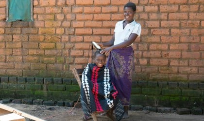 Anes James was able to buy a solar panel and barber equipment with the money she received from Concern Worldwide. Photo: Chris Gagnon