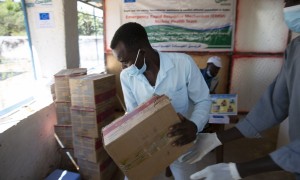 A man in Sudan holds a box of medical supplies